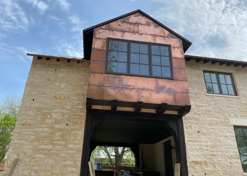 Copper metal panel facade on a stone building for Roof Repair in Redmond